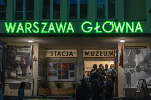Wejście główne do muzeum. Nad wejściem duży zielony neon Warszawa Główna
